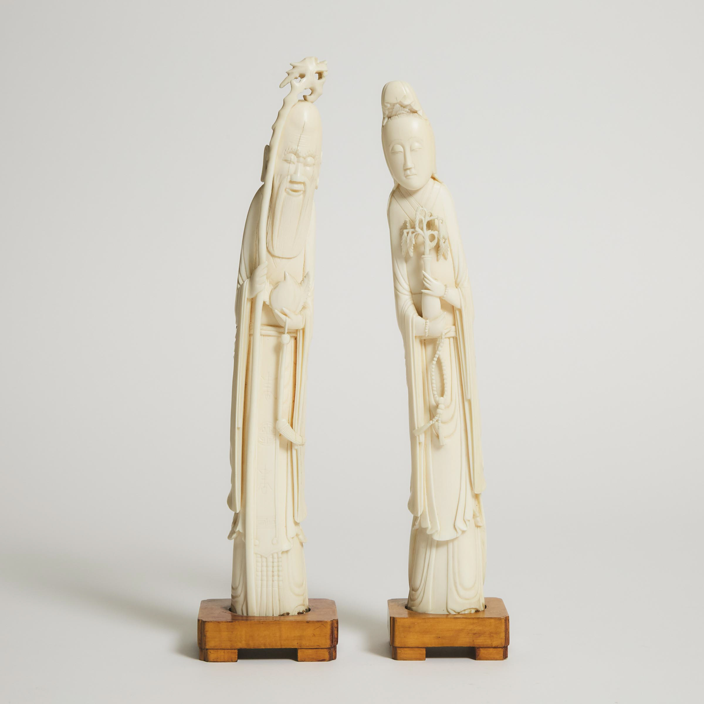 A Pair of Ivory Figures of