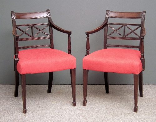 A pair of mahogany armchairs of