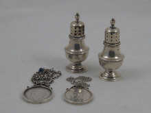 A pair of modern silver pepperettes