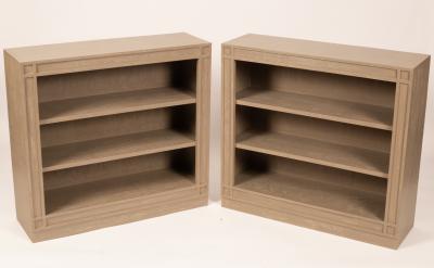 A pair of painted open bookcases by