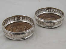 A pair of pierced wine coasters