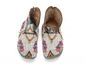 A PAIR OF PLAINS BEADED HIDE M
