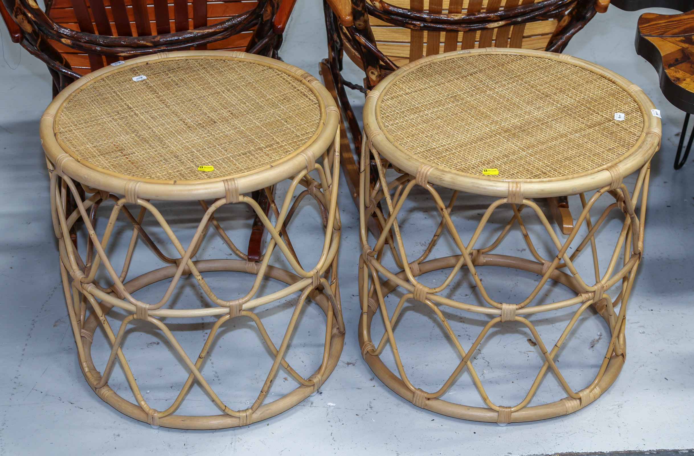 A PAIR OF RATTAN ROUND END TABLES