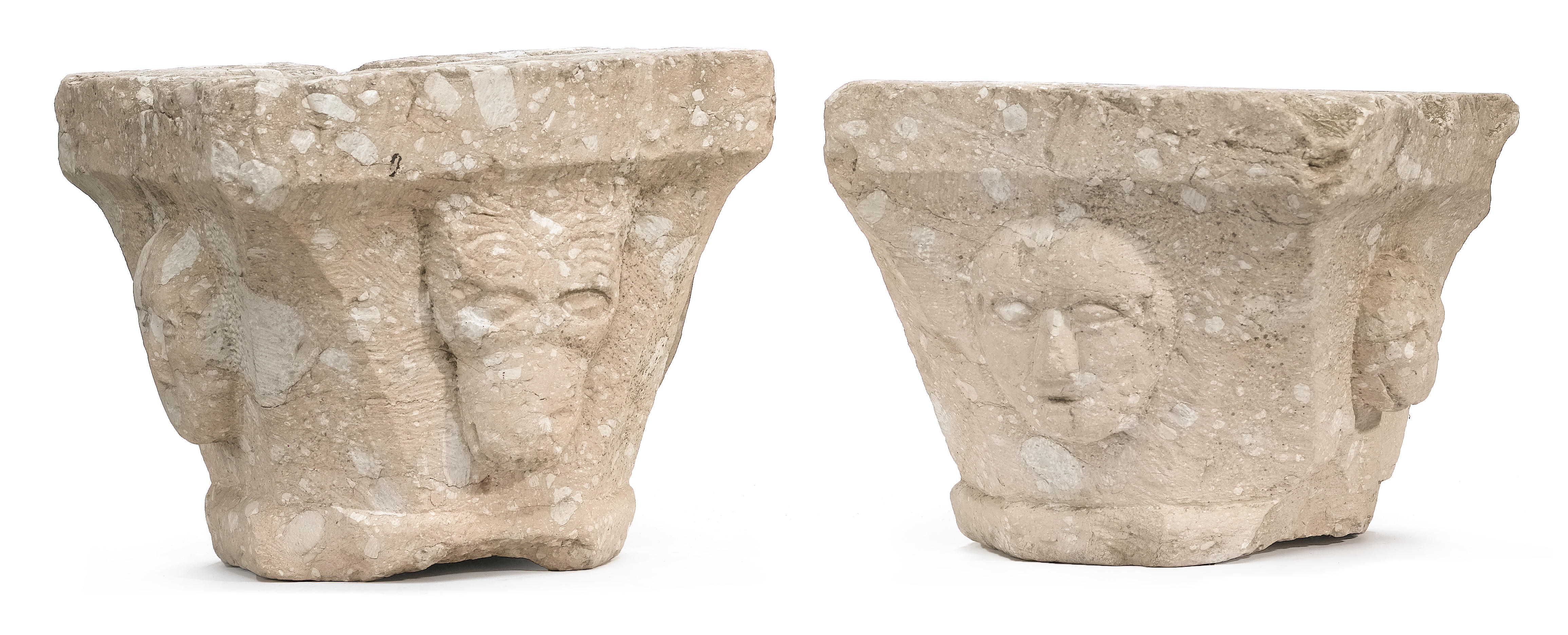 A pair of Romanesque style carved