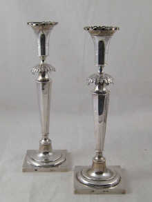 A pair of silver candlesticks the