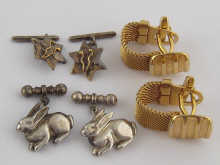 A pair of silver cufflinks designed
