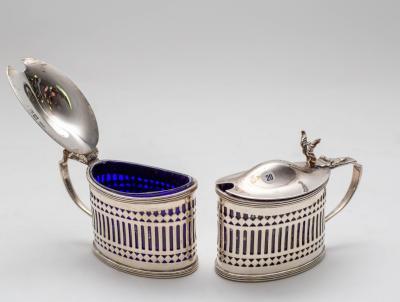 A pair of silver mustard pots,