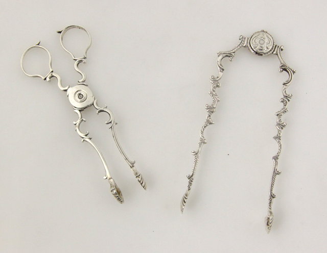 A pair of silver sugar tongs makers