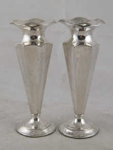A pair of silver tapered incurved