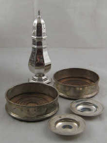 A pair of silver wine coasters with