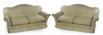 A pair of two-seater sofas