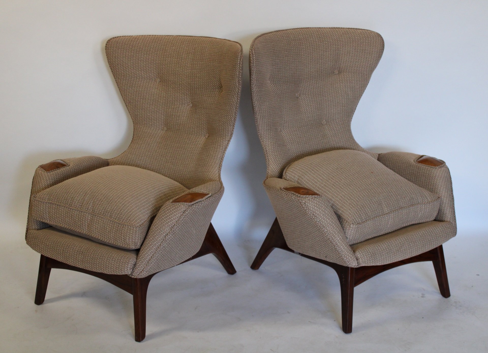 A PAIR OF UPHOLSTERED WING BACK