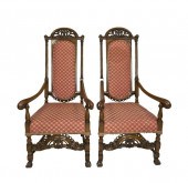 A pair of walnut upholstered a
