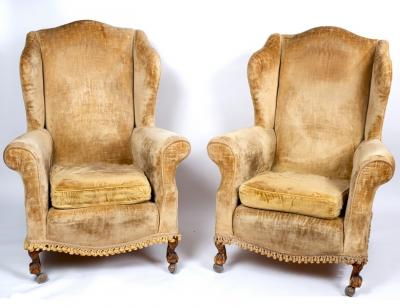 A pair of wing back armchairs, on