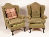 A pair of wingback armchairs o