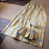 A PAIR OF YELLOW FABRIC CURTAI