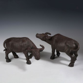 A PAIR OF ZISHA CLAY CATTLE OR