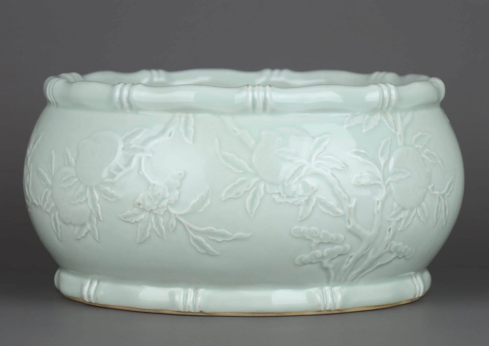 A PALE CELADON-GLAZED CARVED