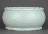 A PALE CELADON-GLAZED CARVED '