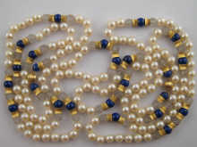 A pearl necklace set with lapis