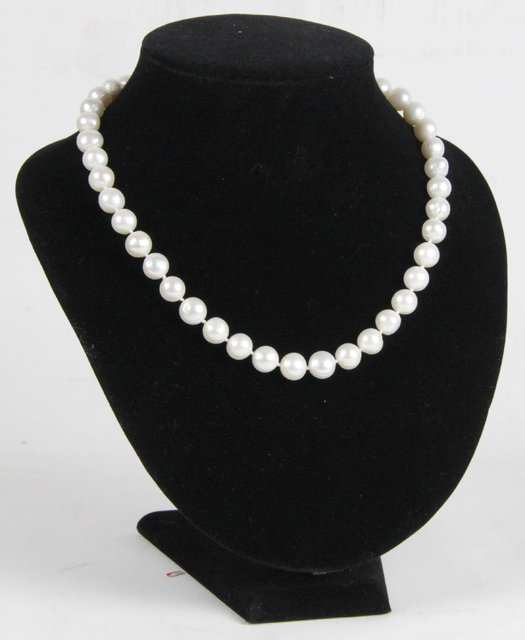 A pearl necklace the clasp marked