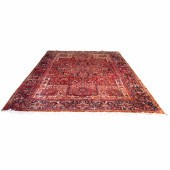 A PERSIAN HERIZ CARPET A Persi