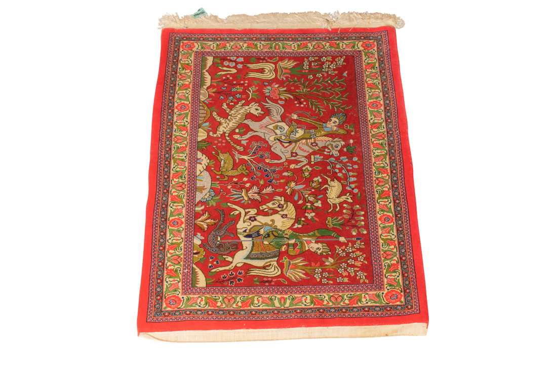 A PERSIAN QUM CARPET A Persian