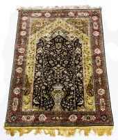 A PERSIAN QUM SILK CARPET A Pe