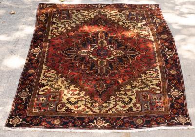 A Persian rug of red and ivory