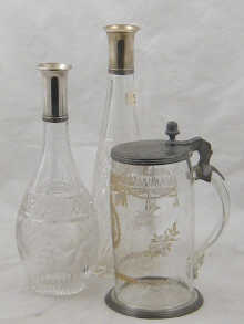 A pewter lidded glass tankard
