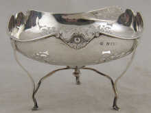A pierced silver bowl on three legs