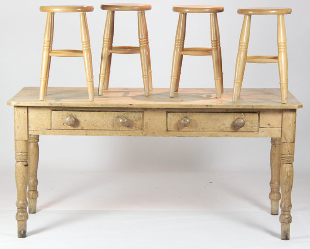 A pine kitchen table with two