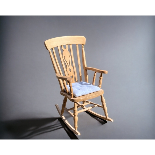 A PINE ROCKING CHAIR.