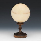 A POLISHED SOLID STONE SPHERE