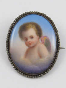 A porcelain brooch depicting a