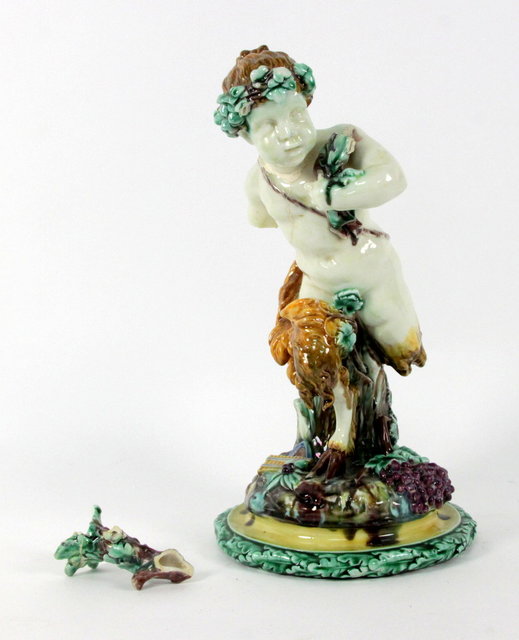 A porcelain figure of a satyr on