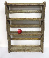 A PRIMITIVE WALL SHELF IN GRAY