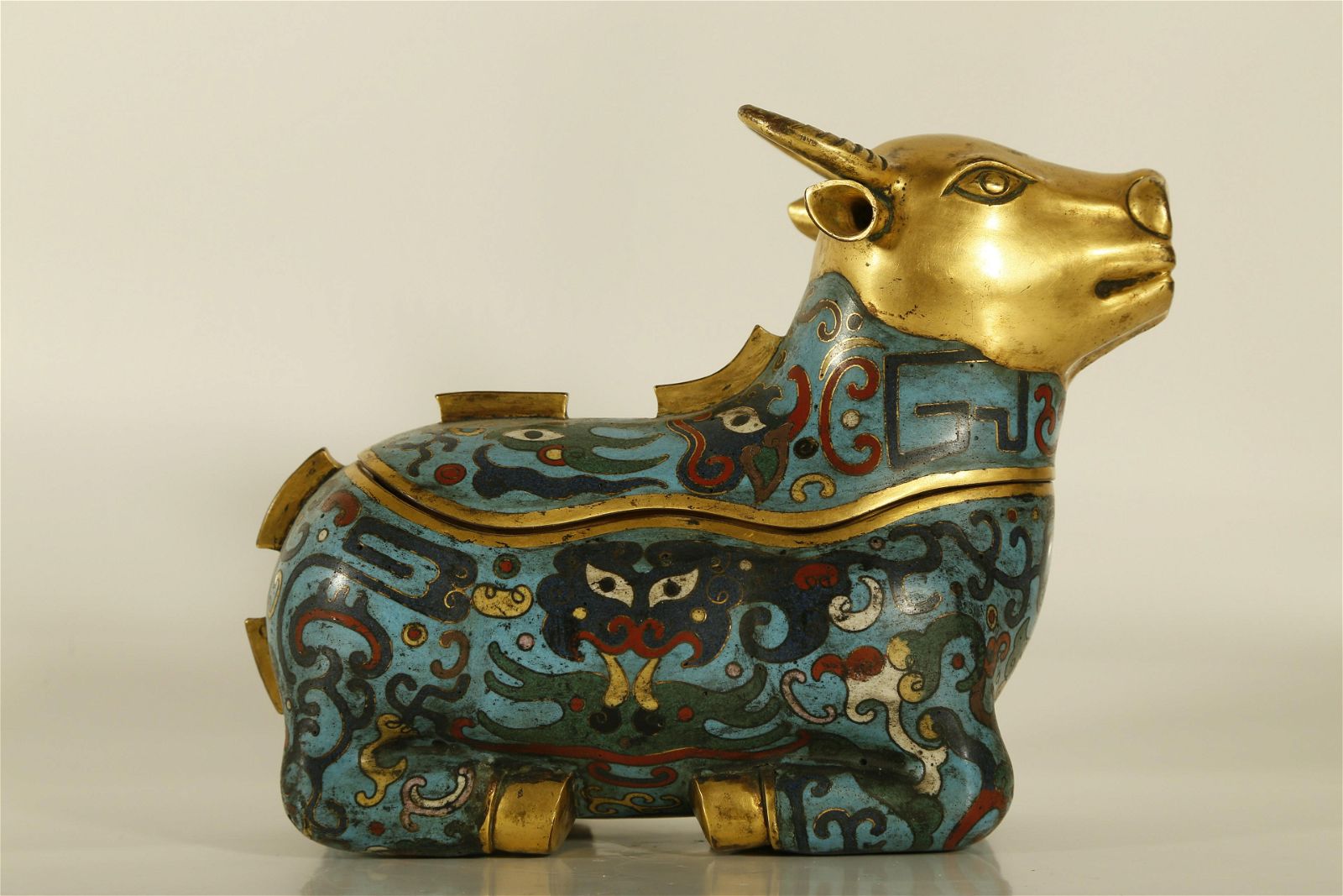 A RARE GILT-CLOISONNE CATTLE-SHAPED