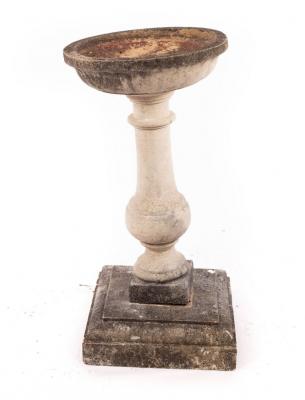 A reconstituted stone bird bath,