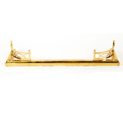A rectangular brass fire fender