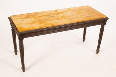 A rectangular marble top table with