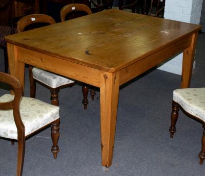 A rectangular pine kitchen table