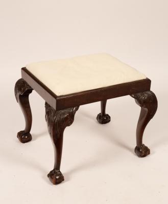 A rectangular stool on carved