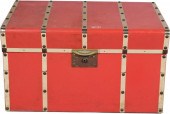 A RED BRASS BOUND TRUNKA MODER