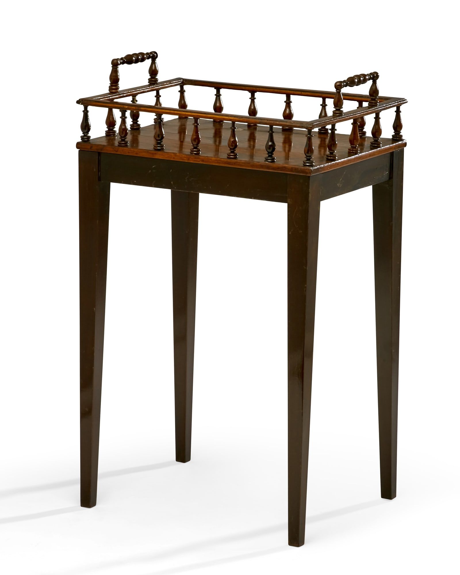 A REGENCY HARDWOOD BOOK TROUGH ON