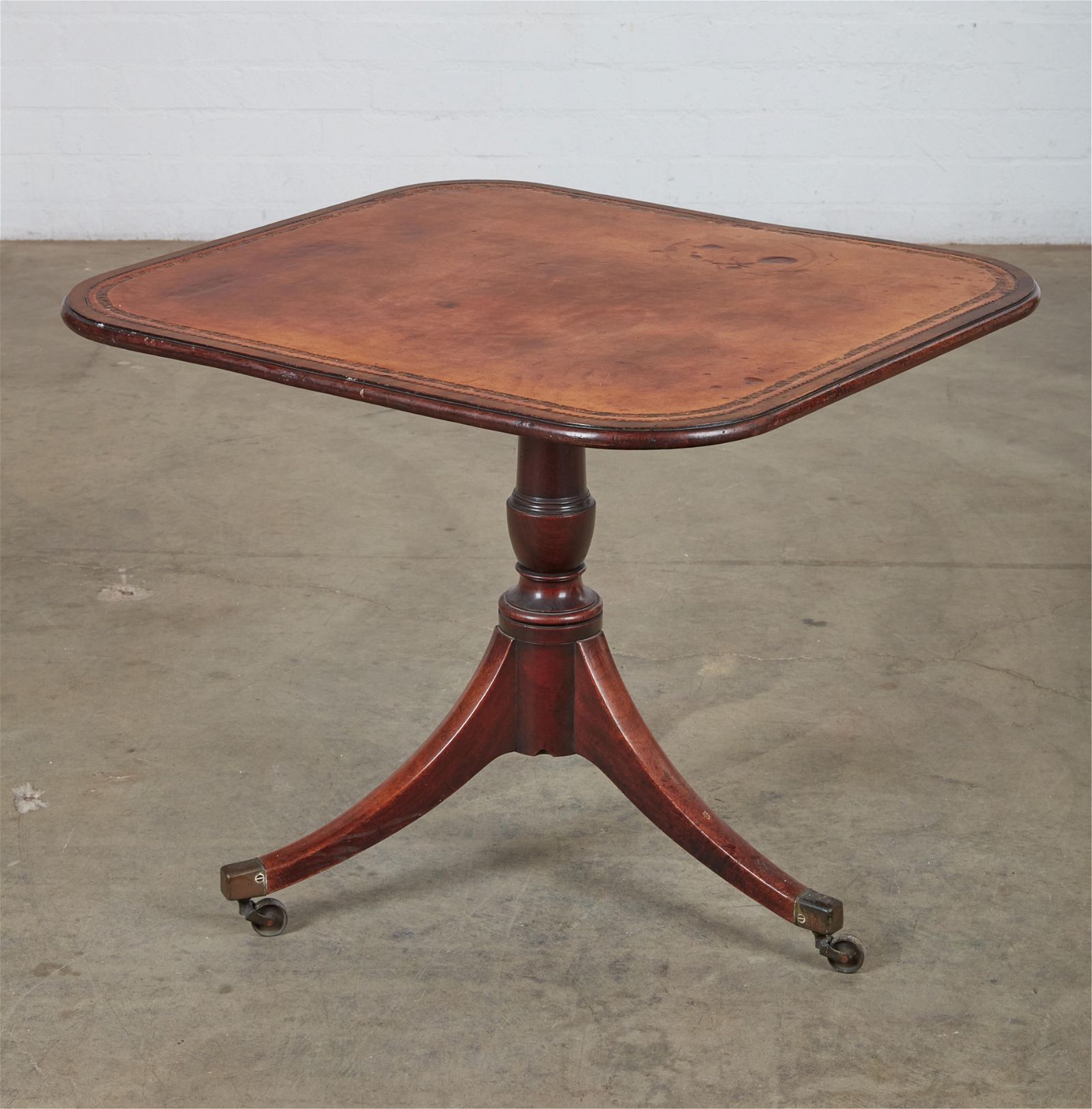 A REGENCY MAHOGANY AND LEATHER TILT