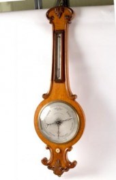 A Regency oak wheel barometer