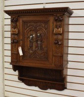 A RELIEF-CARVED OAK WALL CABIN