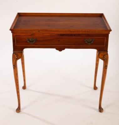 A reproduction silver table, fitted