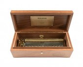 A REUGE WALNUT MUSIC BOX, "CAN